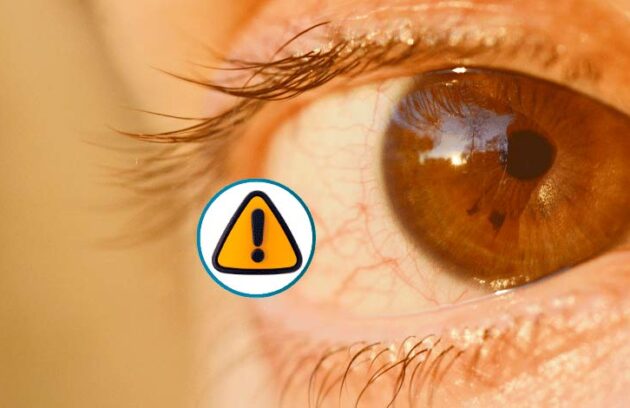 Olho em detalhe com símbolo de atenção